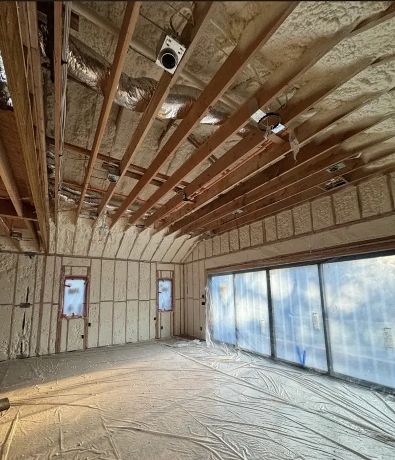 Interior walls and ceiling insulated with spray foam during new construction in DeWitt
